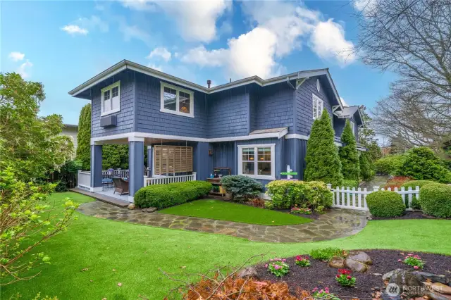Professionally landscaped yard - artificial turf and stone path.