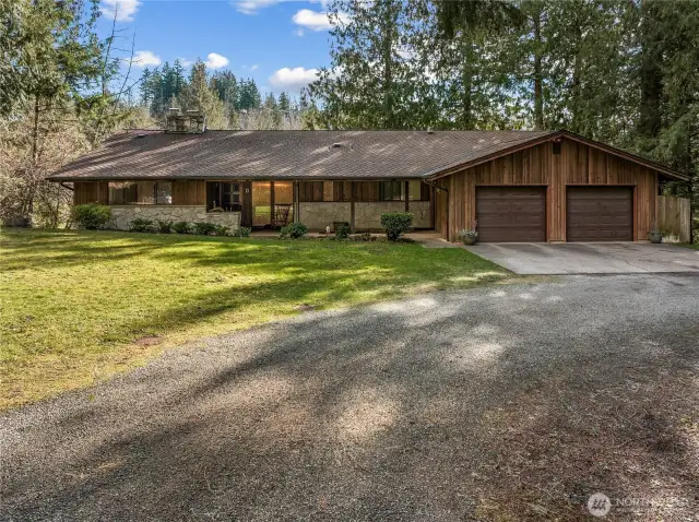 The large semi-circular driveway leads to the driveway, garage, and house.