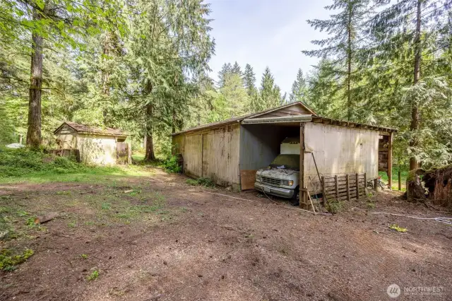 Rare find! A home that comes with a shop. Notice the well house. The well is shared for both homes.