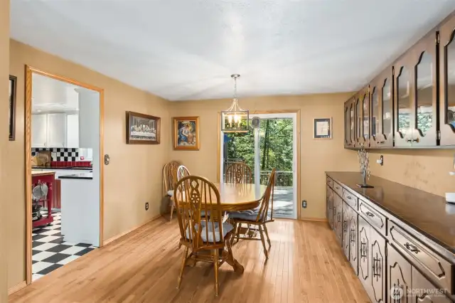 Spacious dining room with built in buffet, cabinetry, and sliding glass door to the patio - perfect for entertaining.