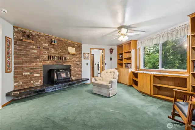 Sun-filled family room featuring a fireplace insert and plenty of space to relax and connect.