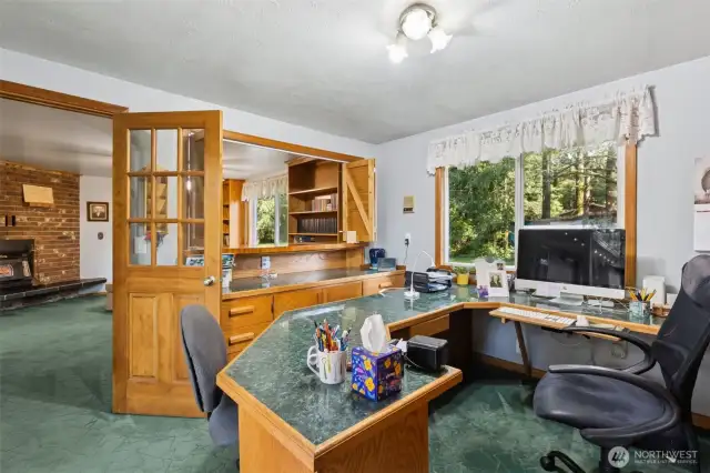 Convenient office space feautring file drawers, clever storage, built ins, and direct access to the patio.