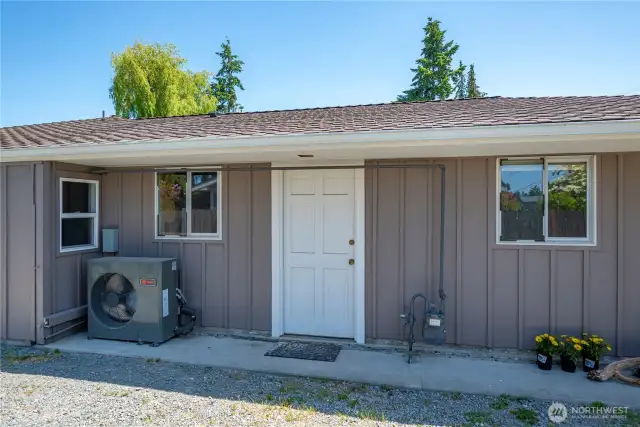 Garage entrance, covered heat pump