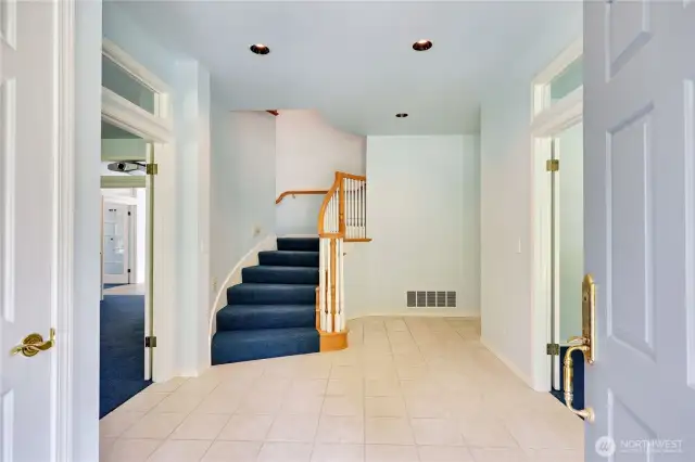 Coming in to the large foyer you see the grand curving staircase.