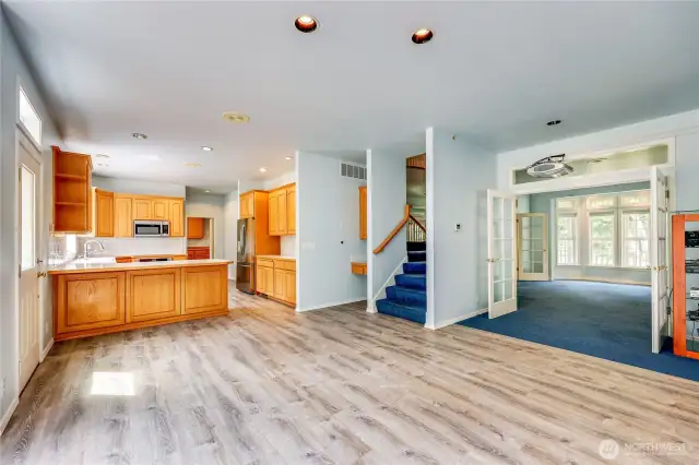 Coming out of family room looking across the eat-in area and kitchen.  Note the second staircase leading to the bedrooms.