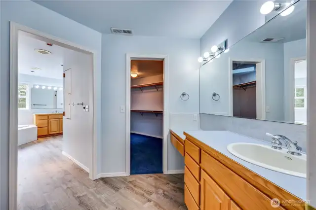 Entering the massive primary bathroom.  First of two separate vanities and walk-in closets.  Water closet off camera on the left