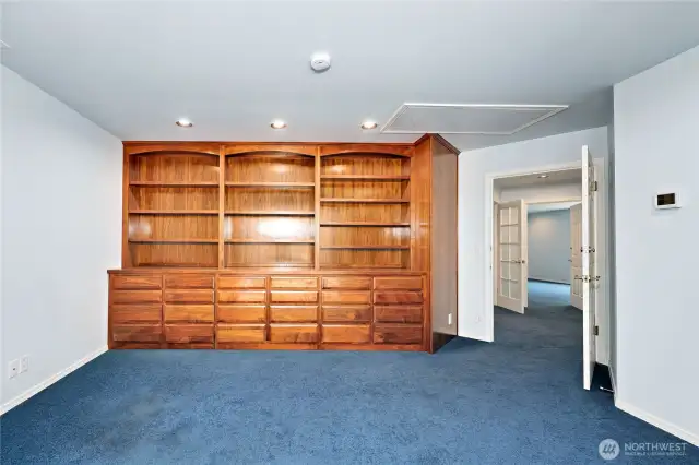 Primary suite office with built-in bookcases and two lockable closets.