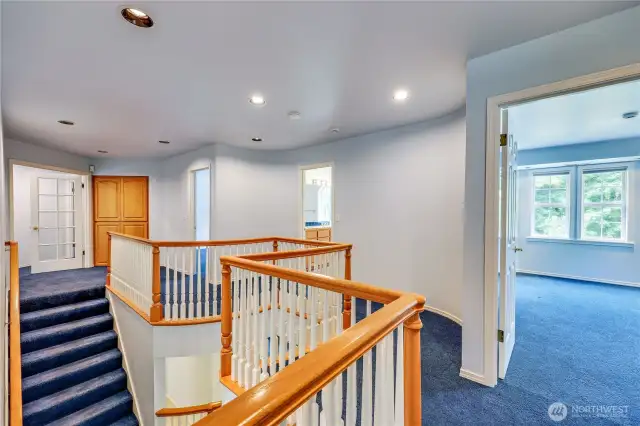 Looking back at hallway from primary suite to the other bedrooms.