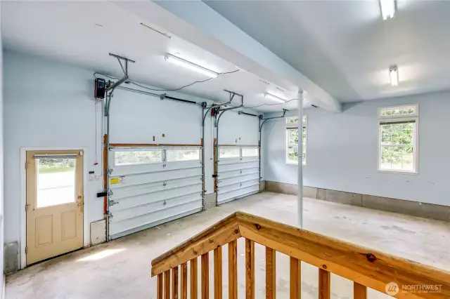 There is a systems room to the left (off camera).  The man door leads to the driveway area.