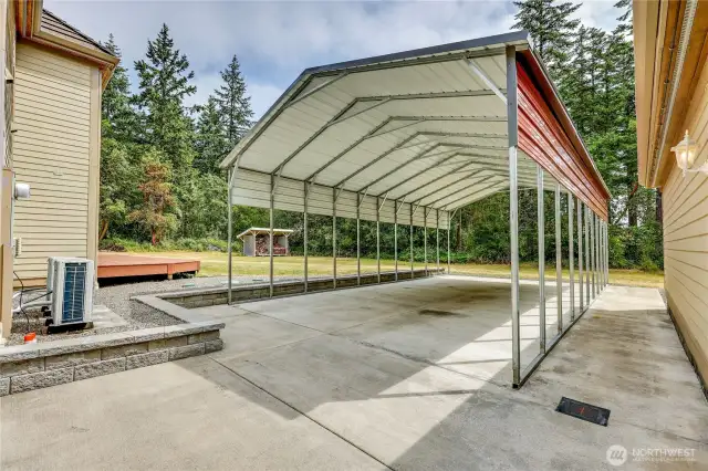 Between the home and the detached garage is a covered parking pad for RV/trailer/boat.