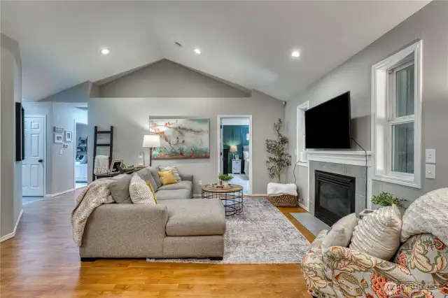 Great room with fresh paint, lighting and vaulted ceilings.