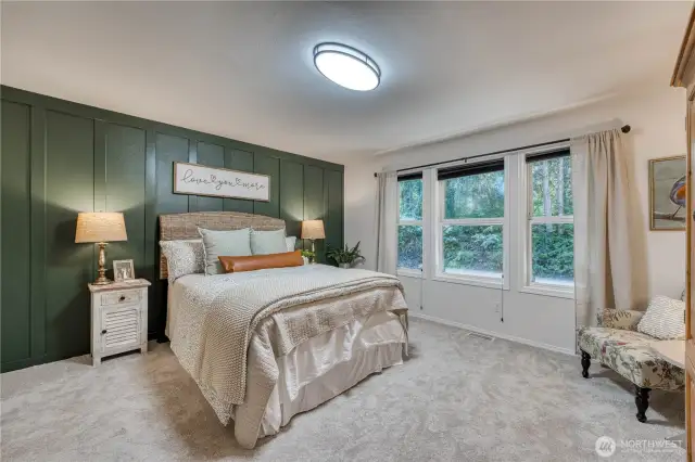 Primary suite with custom designed wall, new carpet, paint and lighting.