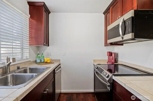 Modern kitchen with stainless steel appliances.