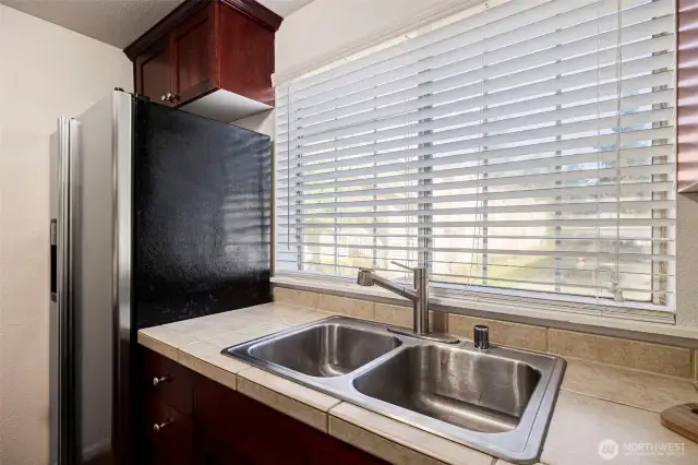 Large kitchen window fills the room with natural light.