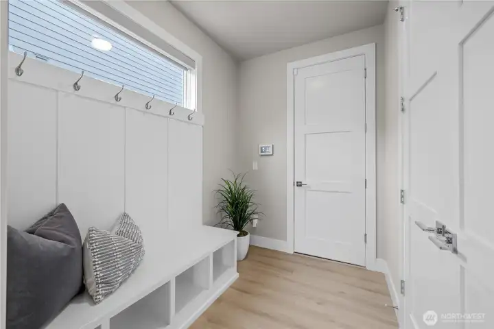 Mudroom with storage closet and garage access – perfect drop zone.