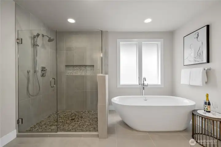 Spa-like primary bath with large shower and freestanding tub.