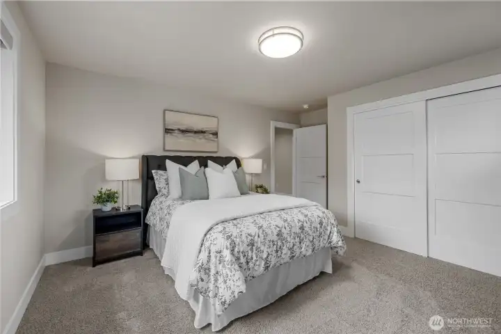 Third bedroom with custom built-in closet drawers and shelving.