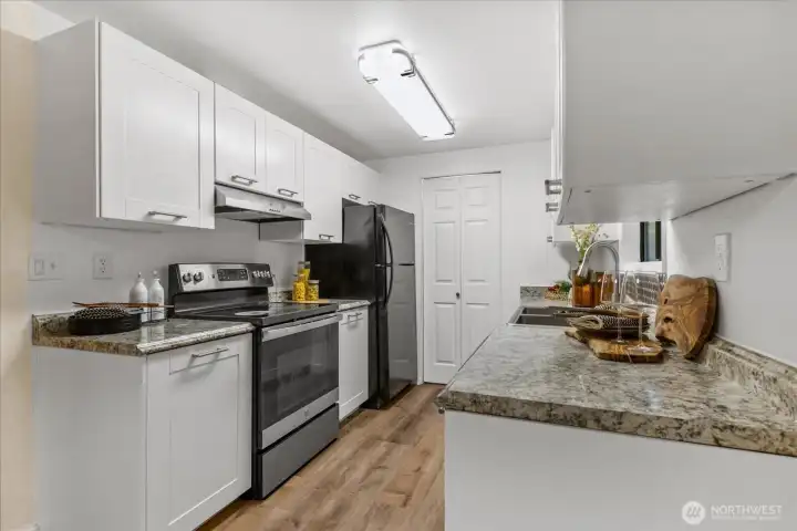 Kitchen with updated appliances and cabinets.