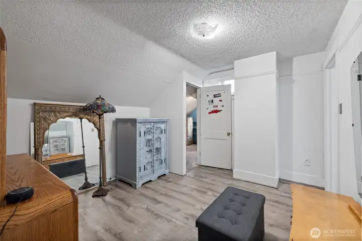 Extra living space upstairs leads to another bedroom thru back door.