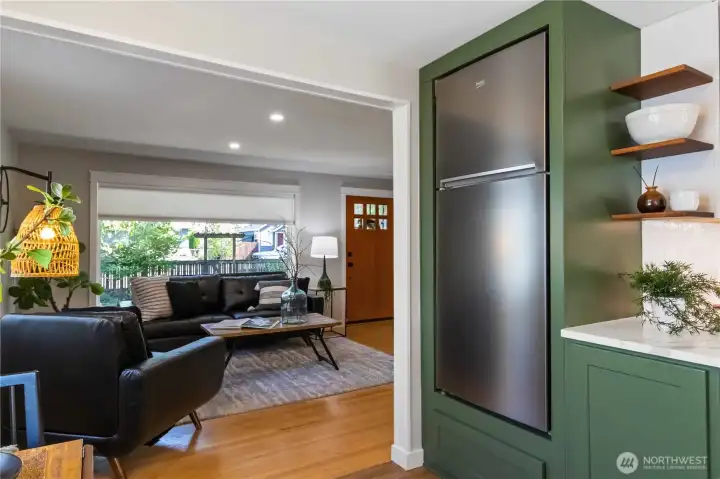 Seamless flow from the modern kitchen into  the inviting living room, highlighting stylish  finishes and natural light.