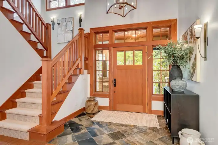 Beautiful two-story entry showcasing the vertical grain fir doors and trim, and slate entry flooring