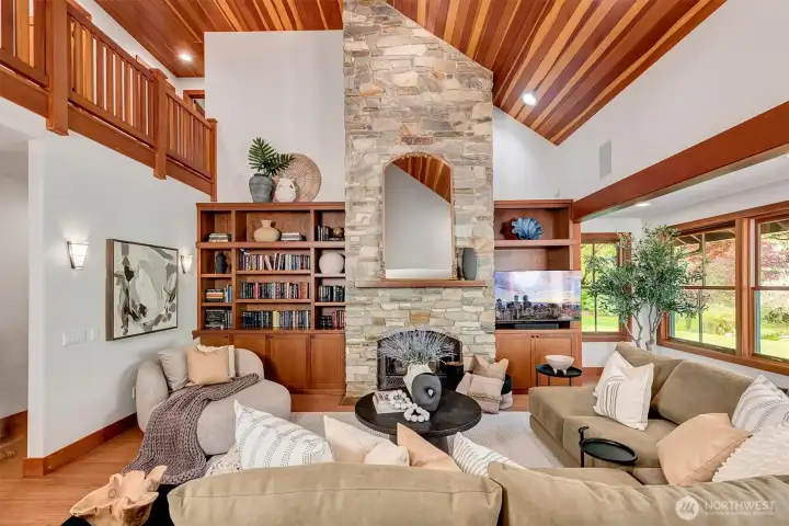 Two story open living room with rich wood detail at every turn