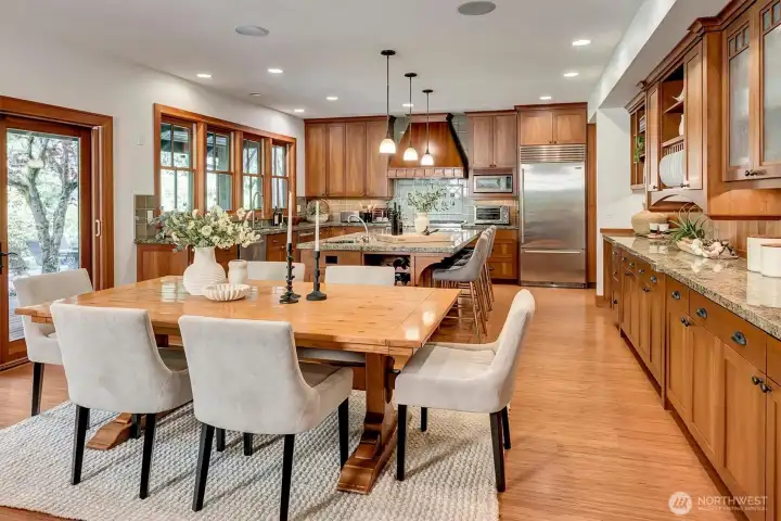 Open Dining and Kitchen with built in storage and shelves and top of the line Wolf and Sub-Zero appliances
