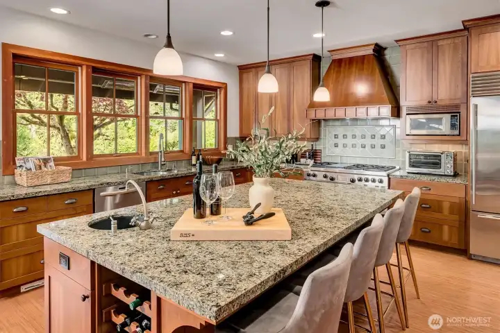 The granite center island offers plenty of storage, and seating for casual dining