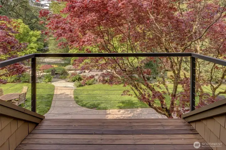Primary bedroom private deck overlooking Pilchuck Creek and the stunning gardens