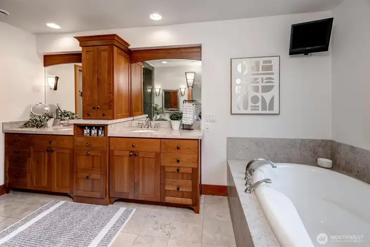 Primary bathroom with soaking tub, built-in vanity, shower, and private toilet