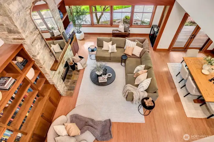 Looking down from the upper hallway at the two-story open living areas