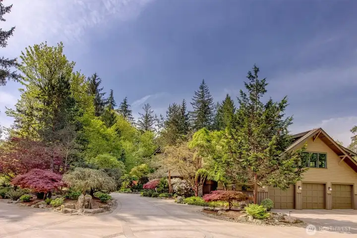 The home features are large circular driveway, and a three-car garage discretely set off the side of the home