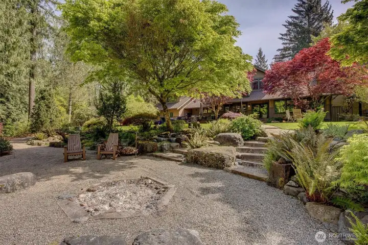 The rear of the home features a covered patio with heat lamps, large patio, outdoor kitchen, stepping down to a generous fire pit overlooking 606 feet of Pilchuck Creek. Keep an eye out for the eagles as they sweep down "Eagle Alley" over the creek