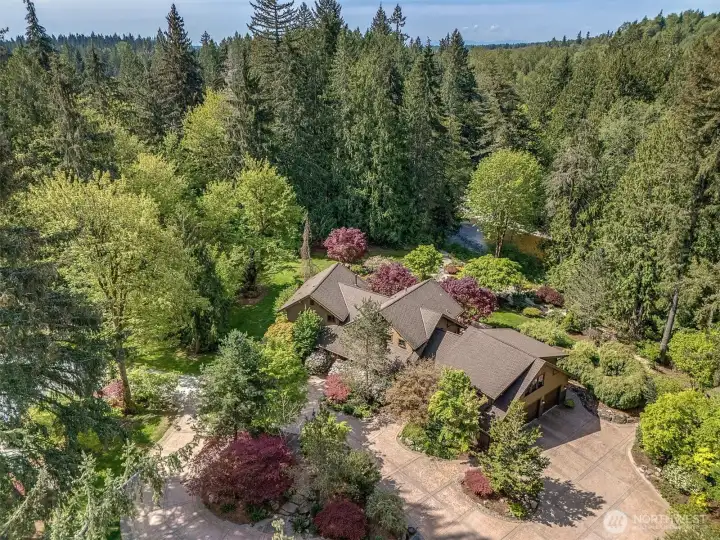 Perfectly sited in manicured gardens with Pilchuck Creek and wildlife at your door