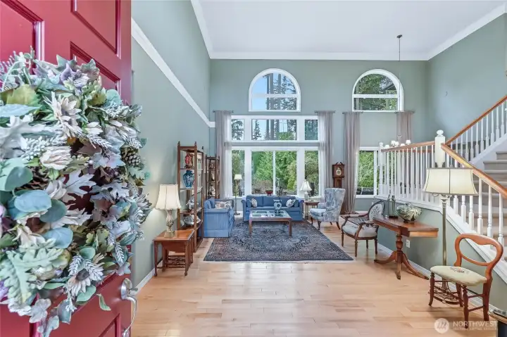 As you step into the home on to warm hardwood floors, your eye is immediately drawn to the cathedral ceilings that frame the yard and evergreens beyond.