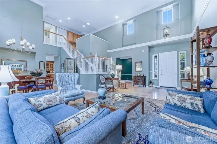 Looking from the formal living room with the dining room to the left and the stairs to the upper level. The office is beyond to the left of the front door.