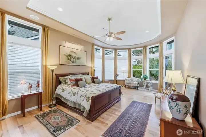 The primary suite is very serene with a lovely curved wall of windows and a glass door to the deck.