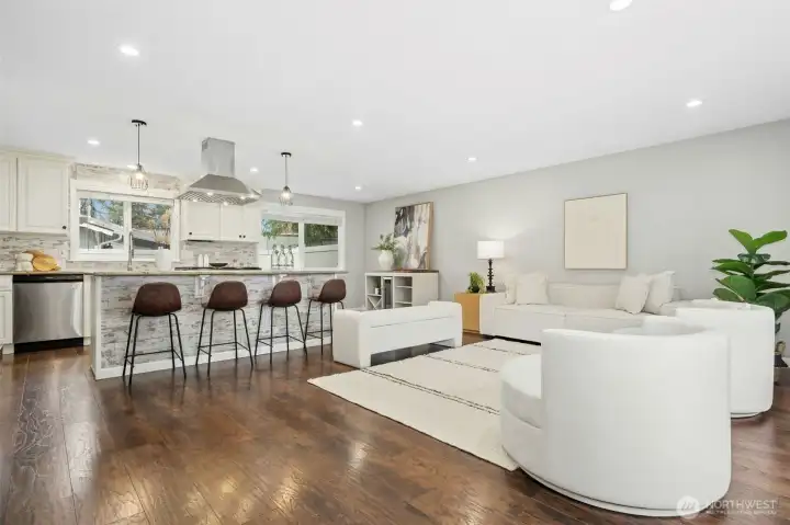 Island seating, cream cabinets and stainless-steel appliances.