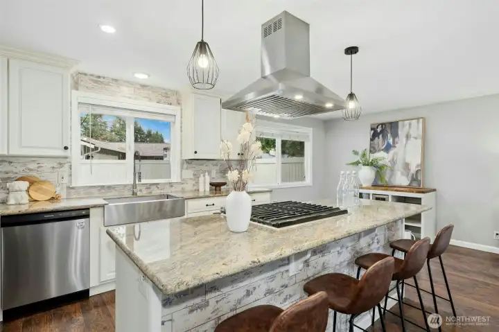 Stainless farm sink is framed by a large window with back yard views.