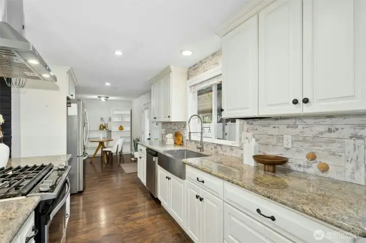Kitchen flows into flex space that can be used for an extension of living area or more of a formal dining space.