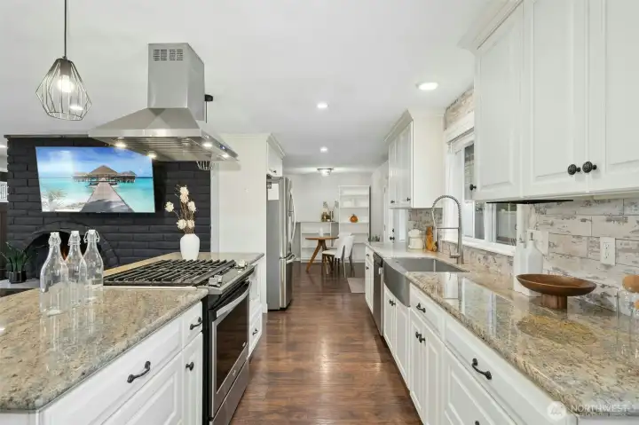 Gas cooking and granite countertops elevate the kitchen space.