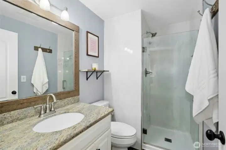 Primary bath is timeless + well-kept.