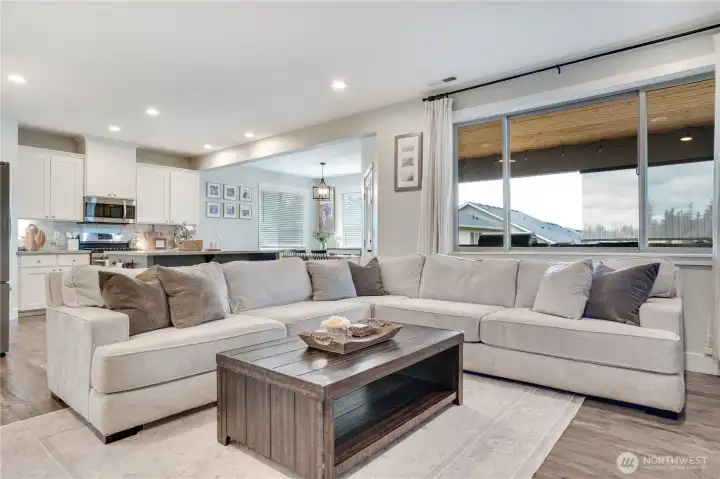Spacious open-concept living room featuring a cozy fireplace—perfect for both everyday living and entertaining