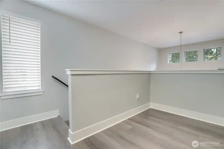 Versatile landing at the top of the stairs—ideal for a reading nook, office, or flex space