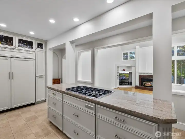 Bright and beautiful kitchen with Wolf stovetop.  Looking into family room.