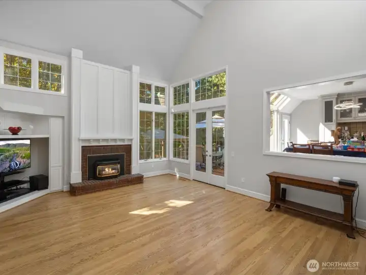 Family room is sunken and has access to back deck and yard.  Gas fireplace.  HUGE Vaulted ceiling with skylights.  Peek-a-boo view into the kitchen eating space / sun room.