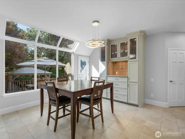 Off kitchen eating space with access to back deck and yard.  New lighting.  Freshly painted.  Lots of storage.  aka:  sun room.  These south facing windows are new and updated with UV protectant.