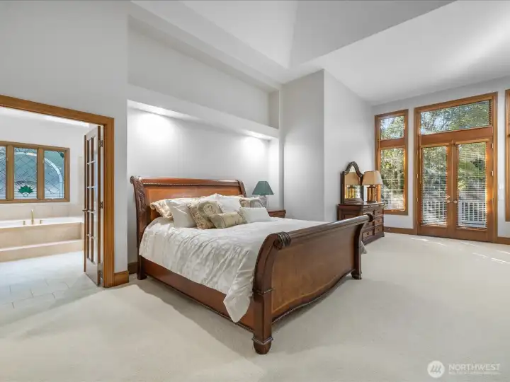 Wonderful Primary bedroom on the main floor with vaulted ceiling, luxury bathroom, gas fireplace, access to back deck, and large walk-in-closet.