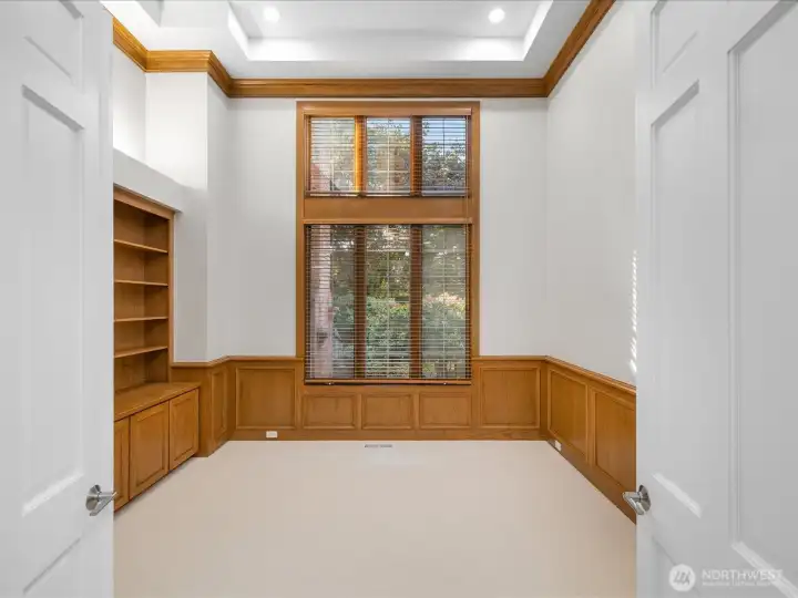 Office / Den with custom wooden bookshelfs.
