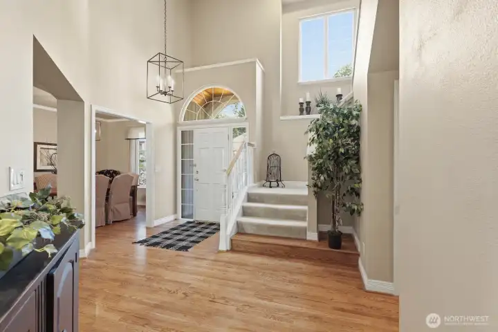 A grand, light-filled entry welcomes you with soaring ceilings, hardwood floors, and timeless architectural details.
